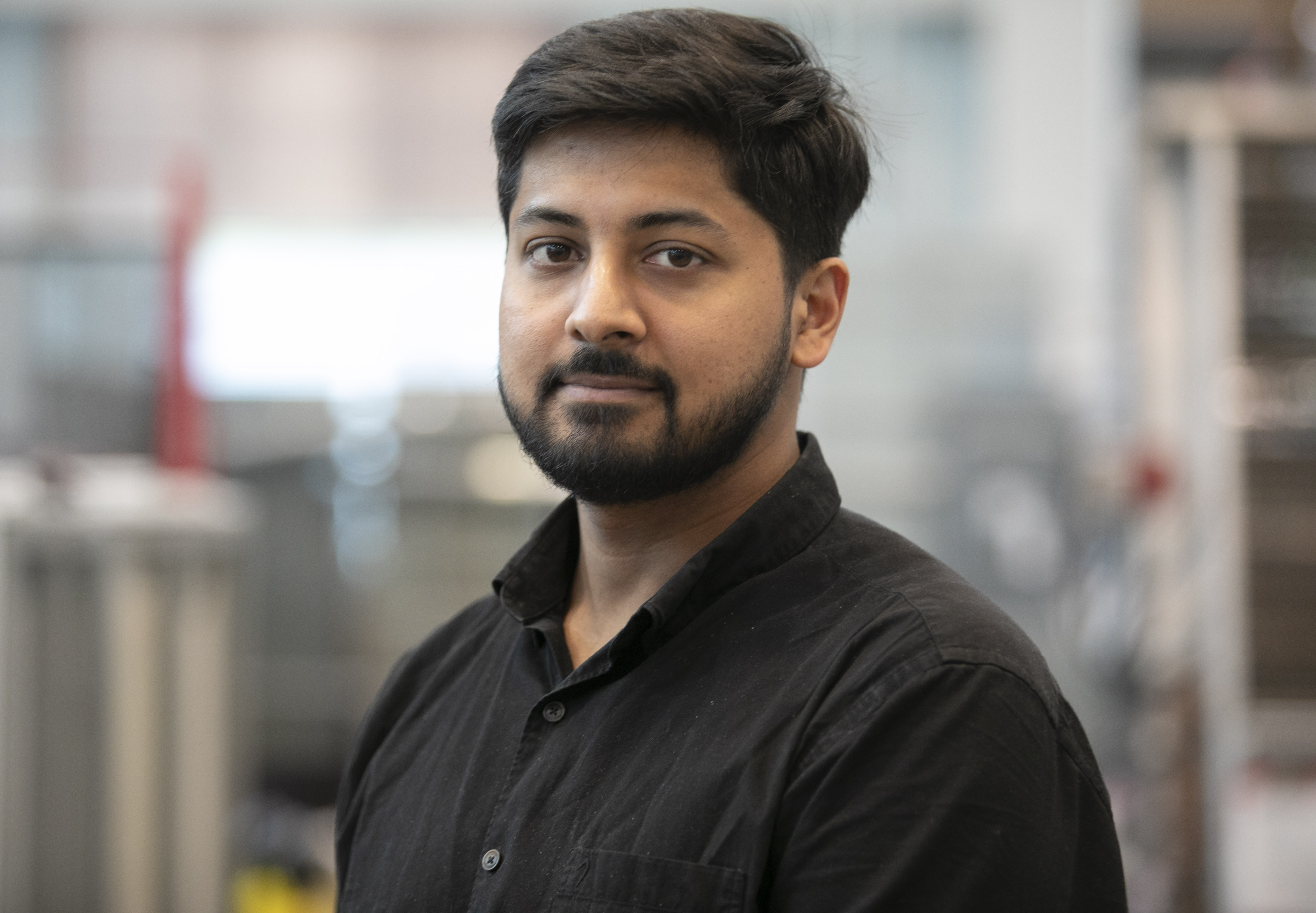 Graduate student standing in lab